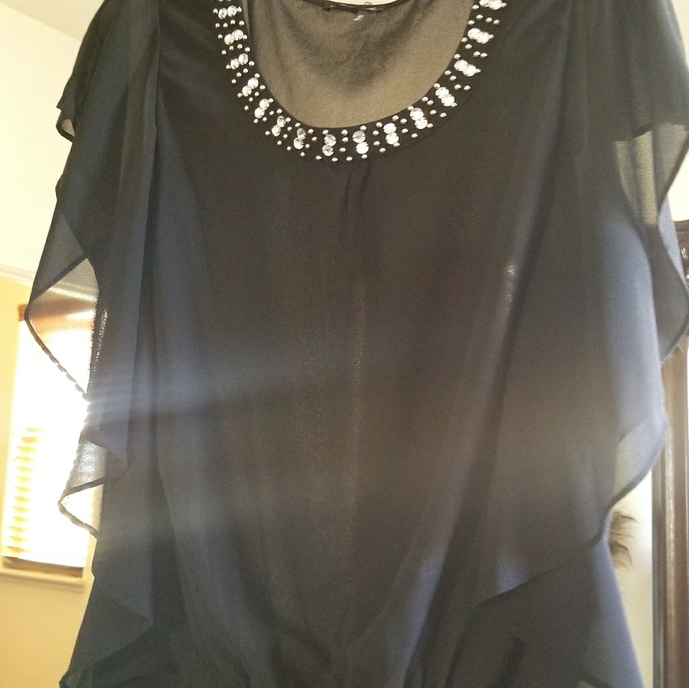 Black chiffon top with embellishments.